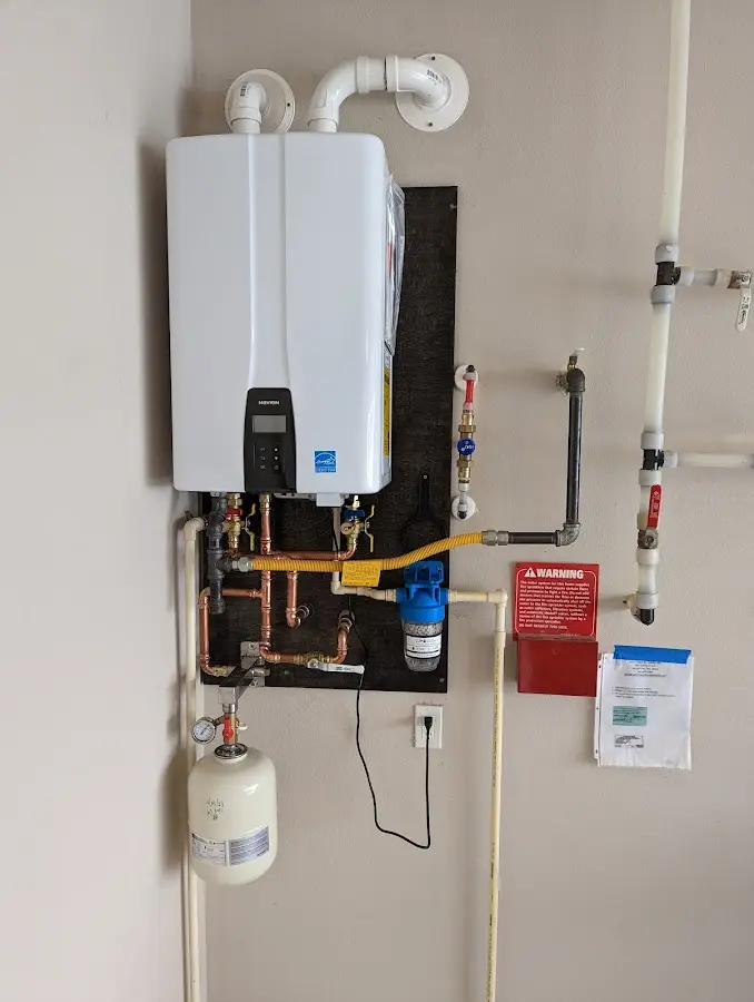 Professional plumber installing copper piping in a Roanoke home